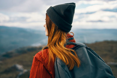 Rear view of woman looking at camera