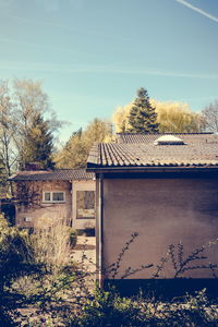 House on field against clear sky