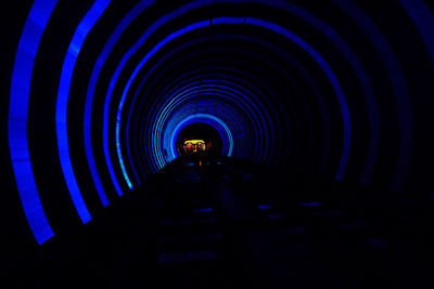 People in illuminated tunnel