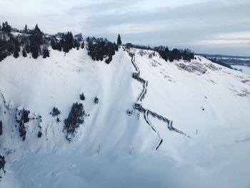 Scenic view of snow covered land against sky