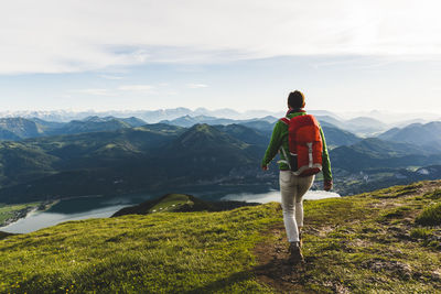 Austria, salzkammergut, hiker with backpack hiking in the alps