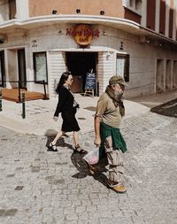 People walking on sidewalk in city