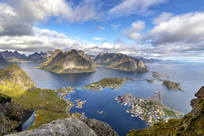 Scenic view of sea and mountains against sky