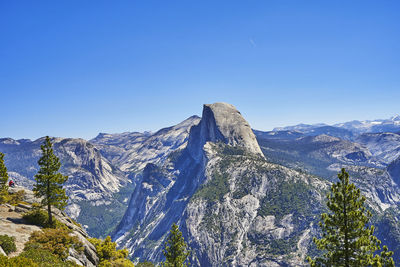 Scenic view of snowcapped mountains against clear blue sky