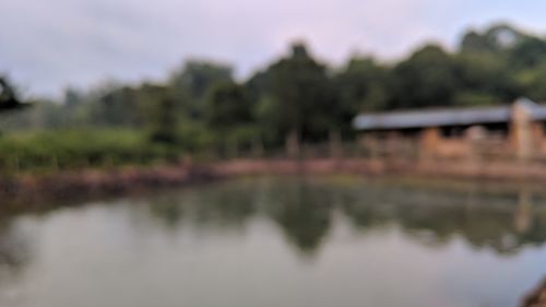 Reflection of building in lake against sky