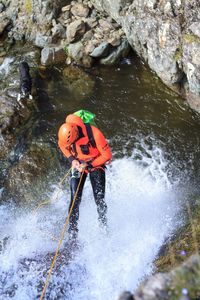 High angle view of person standing on rock