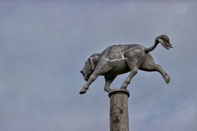 Low angle view of statue against sky