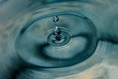 High angle view of drop falling on water