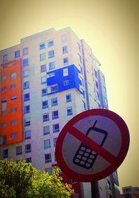 Low angle view of road sign against clear sky