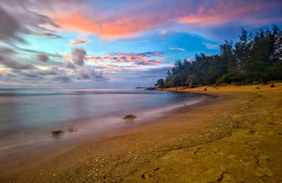 Scenic view of beach against sky during sunset