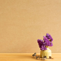 Close-up of purple flower vase on table