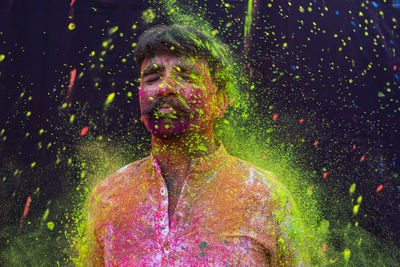 Man with colorful powdered paint during holi