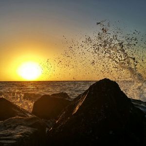 Scenic view of sea against clear sky during sunset