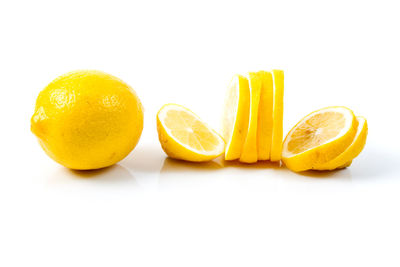 Close-up of yellow fruits on white background
