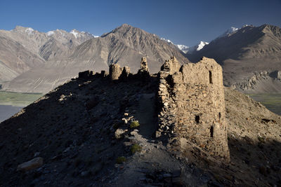 Yamchun fortress overlooking wakhan valley in tajikistan. in the background, afghanistan mountains