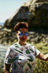 Portrait of man wearing sunglasses standing outdoors