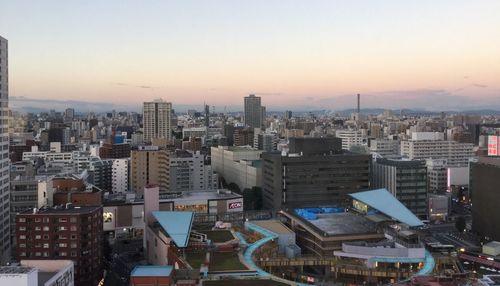 Cityscape against clear sky during sunset