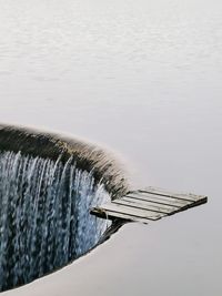 High angle view of water flowing over lake