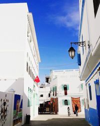 Street amidst buildings in city against sky