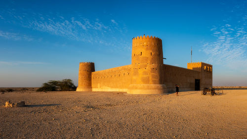 Old ruin building against blue sky