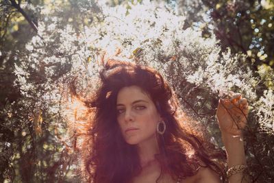 Portrait of woman against plants