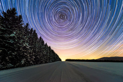 Road against sky at night