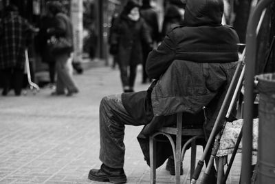 Rear view of person sitting on chair