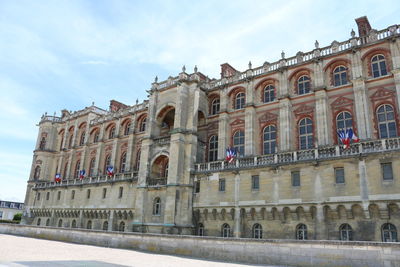 Low angle view of historical building against cloudy sky