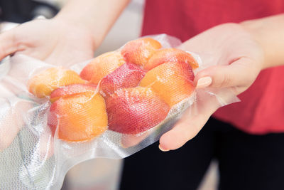 Close-up of hand holding fruits