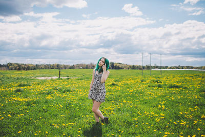 Rear view of woman standing on field