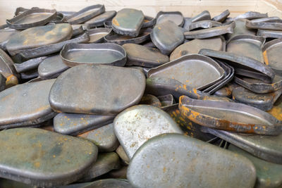 Full frame background of many stamped parts made of sheet metal after draw operation