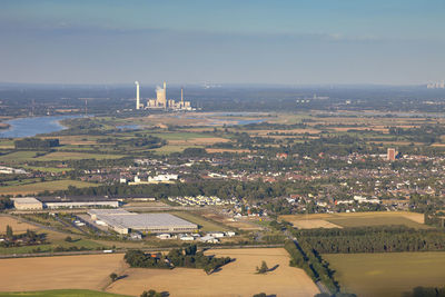 Aerial view of factory on field against sky