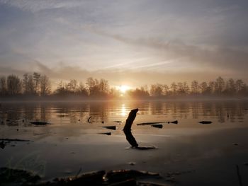 Scenic view of lake against sky during sunset