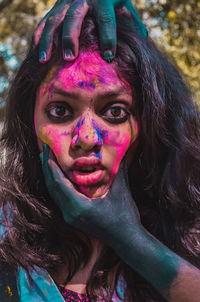 Portrait of beautiful woman with multi colored face