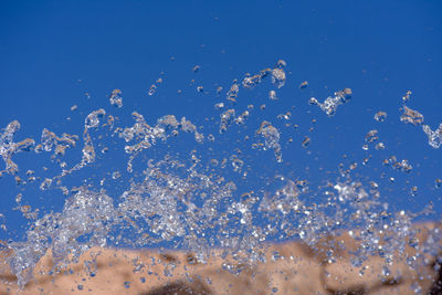 Low angle view of bubbles against clear sky