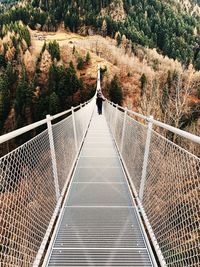 Rear view of person on footbridge