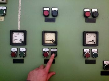 Cropped image of hand pressing push button