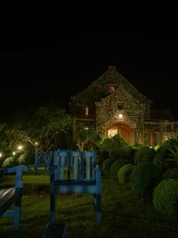 Illuminated building against sky at night