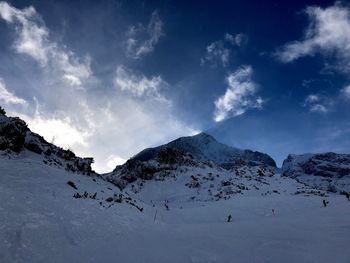 Scenic view of snow covered mountains against sky