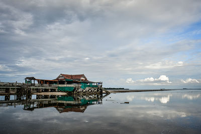 View of lake by building against sky