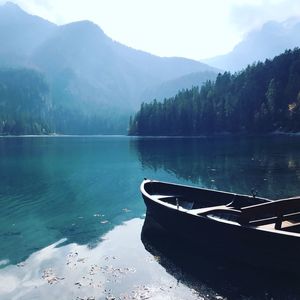 Scenic view of lake by mountains against sky