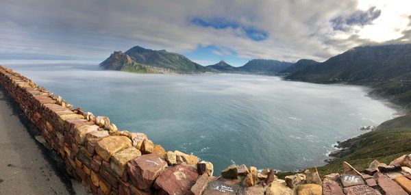 Panoramic view of sea and mountains against sky