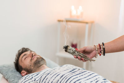 Cropped hand of woman applying medicine at home