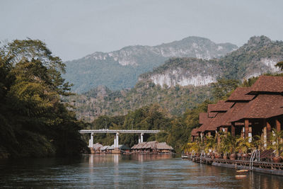 Scenic view of lake and buildings against sky