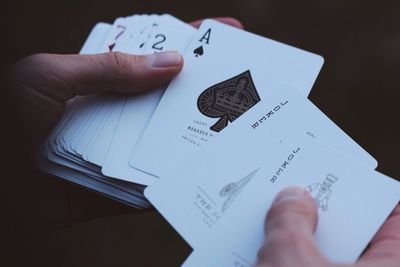 Close-up of hands holding playing cards