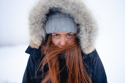 Portrait of young woman wearing hat during winter