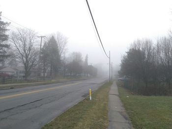 Man on road against sky