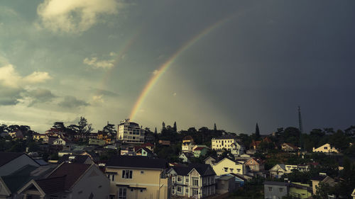 Rainbow over buildings in town