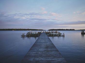 Pier over lake against sky