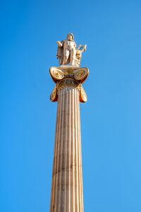 Low angle view of statue against blue sky